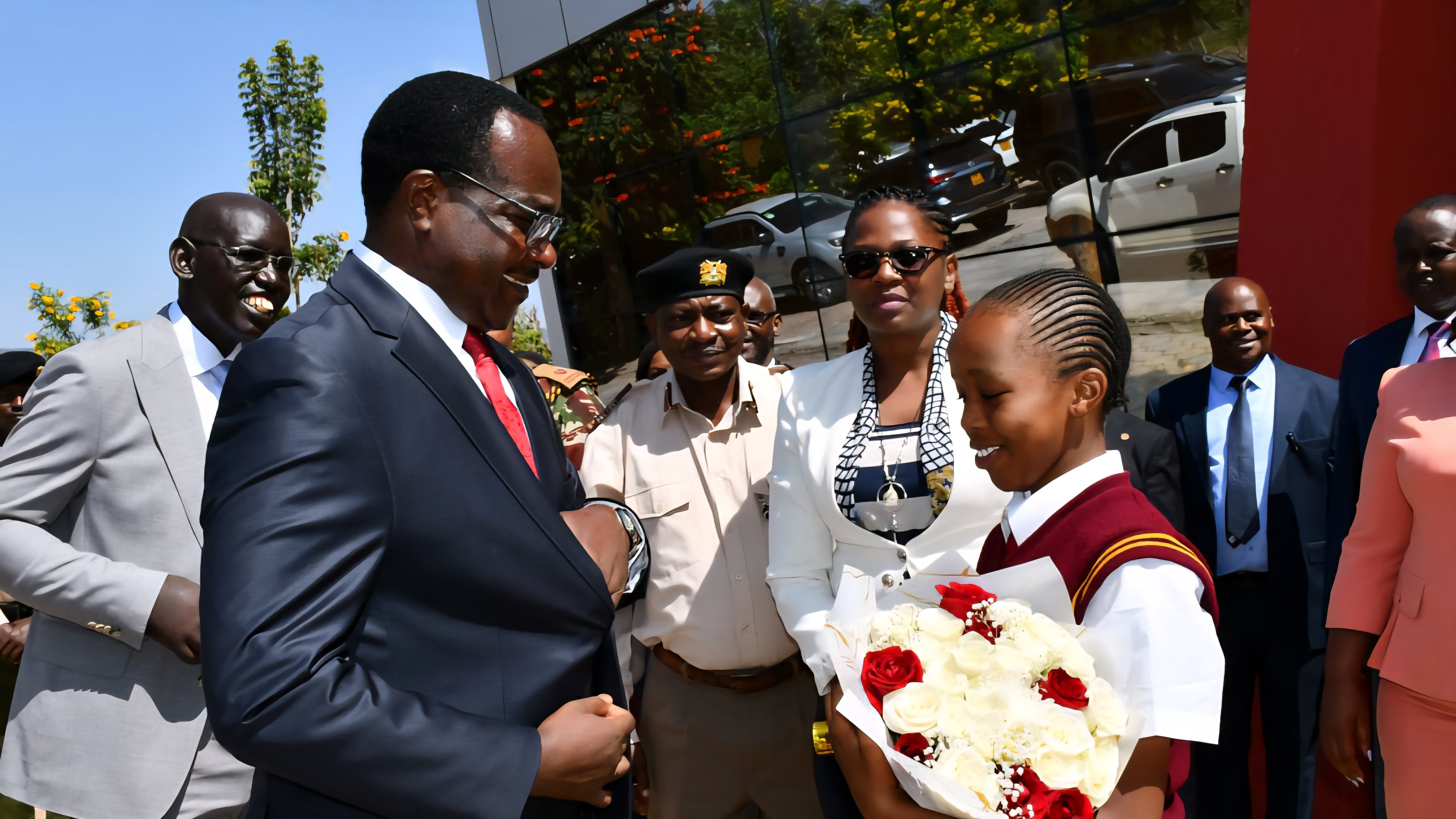 Kenya Ministry of Education officials and stakeholders inspecting educational materials at a public event stand.