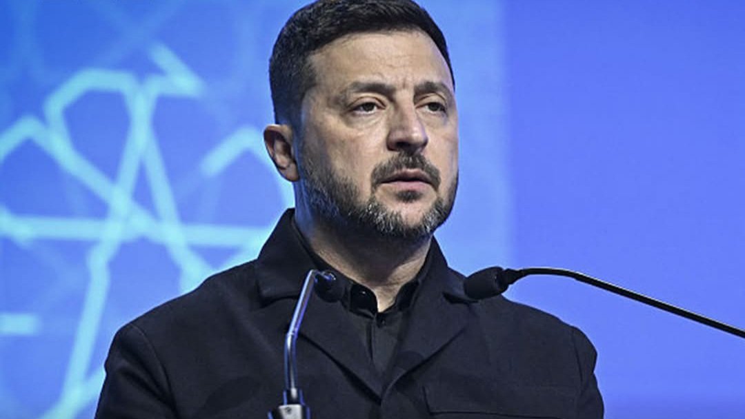 Ukrainian President Volodymyr Zelensky speaking at a podium during a diplomatic summit.