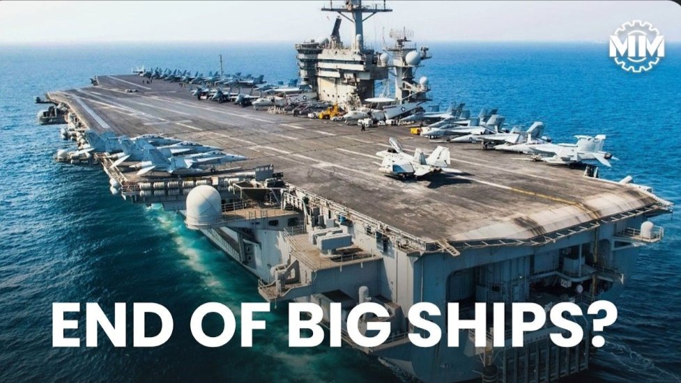 A large United States Navy aircraft carrier at sea carrying multiple fighter jets on its flight deck, as featured in the military mechanics.