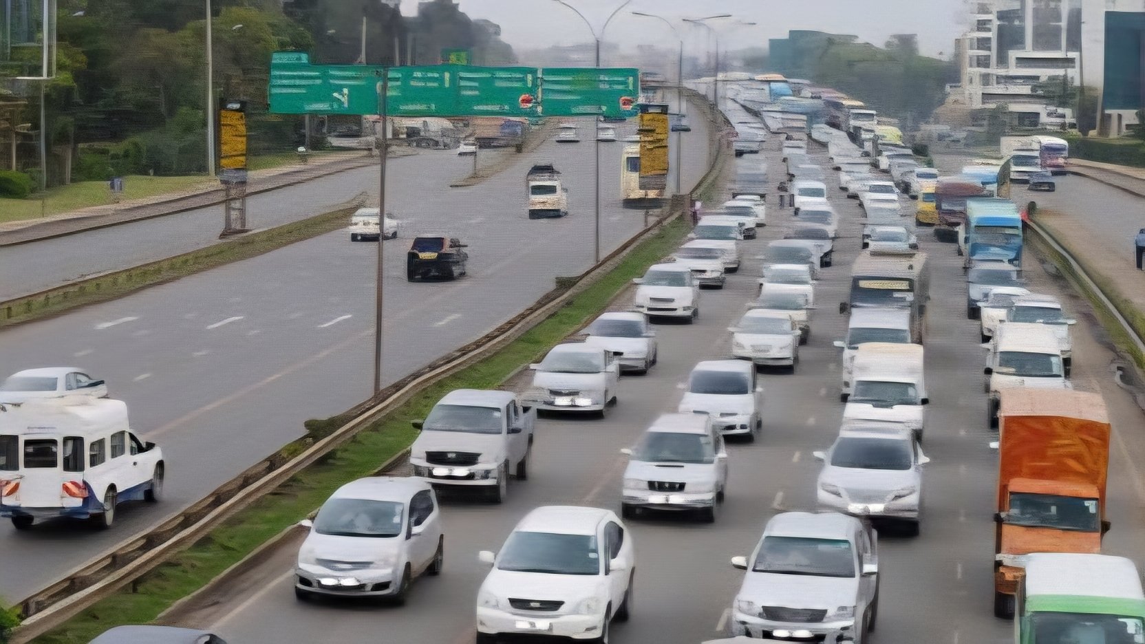 Aerial view of a congested two-lane highway in Kenya featuring heavy commercial trucks and long-distance transit vehicles.