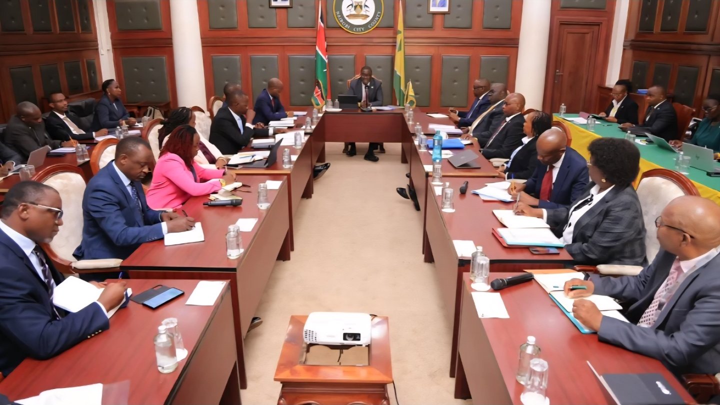 Nairobi Governor Johnson Sakaja chairing a meeting with government officials at a long boardroom table at City Hall.
