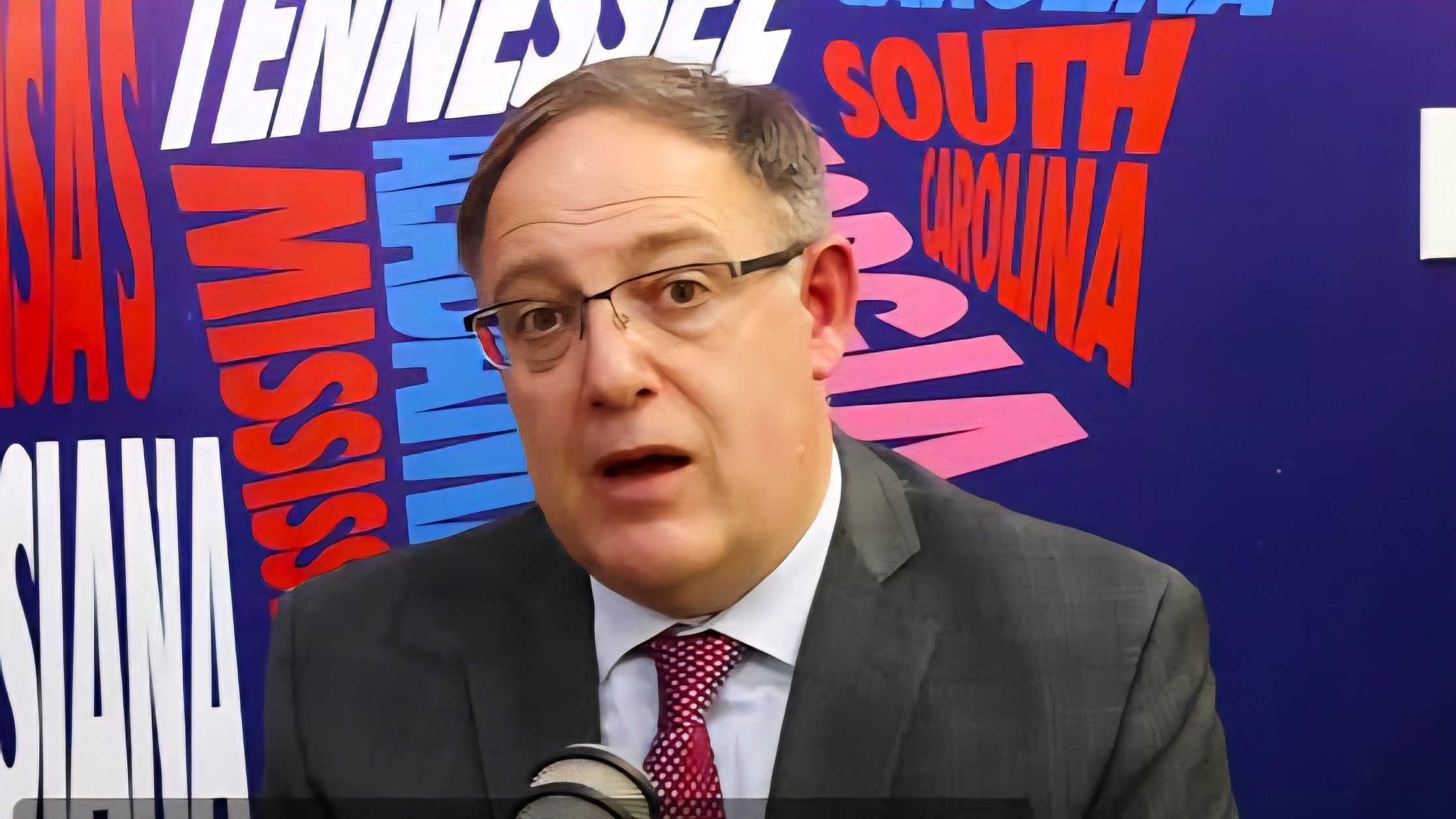 Close-up of US Consul General Nathan Flook speaking at a press briefing regarding visa compliance and travel statistics for Kenyan citizens.