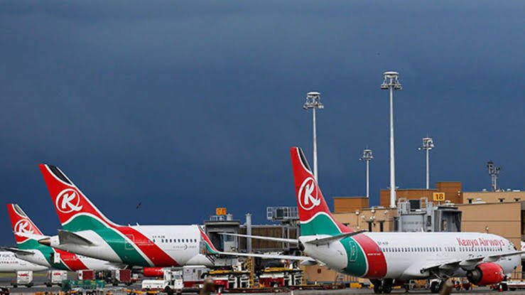 Kenya Airways aircraft parked at a terminal gate at Jomo Kenyatta International Airport in Nairobi.