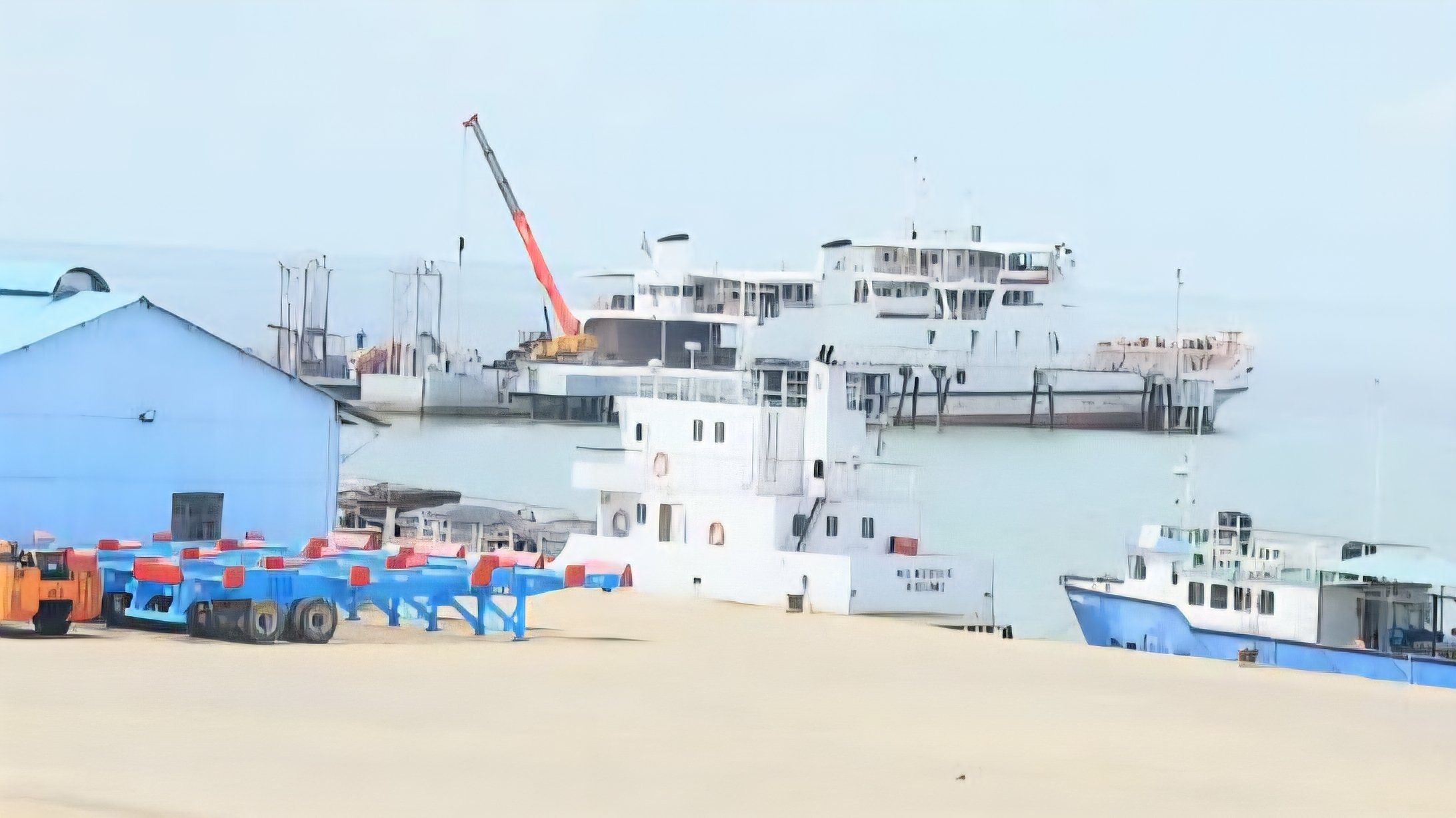 A large cargo vessel docked at Kisumu Port on Lake Victoria with industrial buildings and containers in the background.
