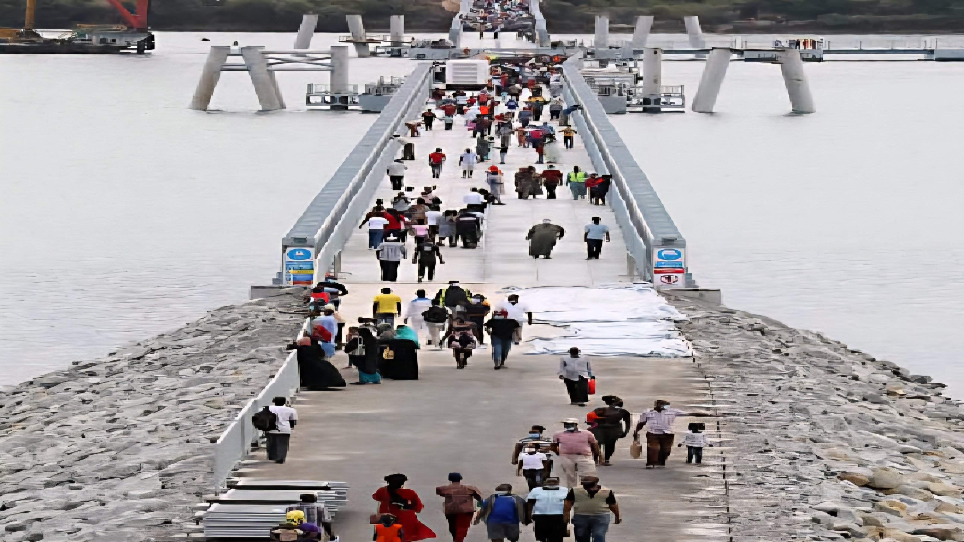 The Liwatoni Floating Bridge stretching across the Kilindini Harbour in Mombasa with the city skyline in the background.