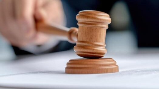 A close-up view of a legal gavel resting on a wooden desk inside a Kenyan courtroom, symbolizing the Court of Appeal ruling.