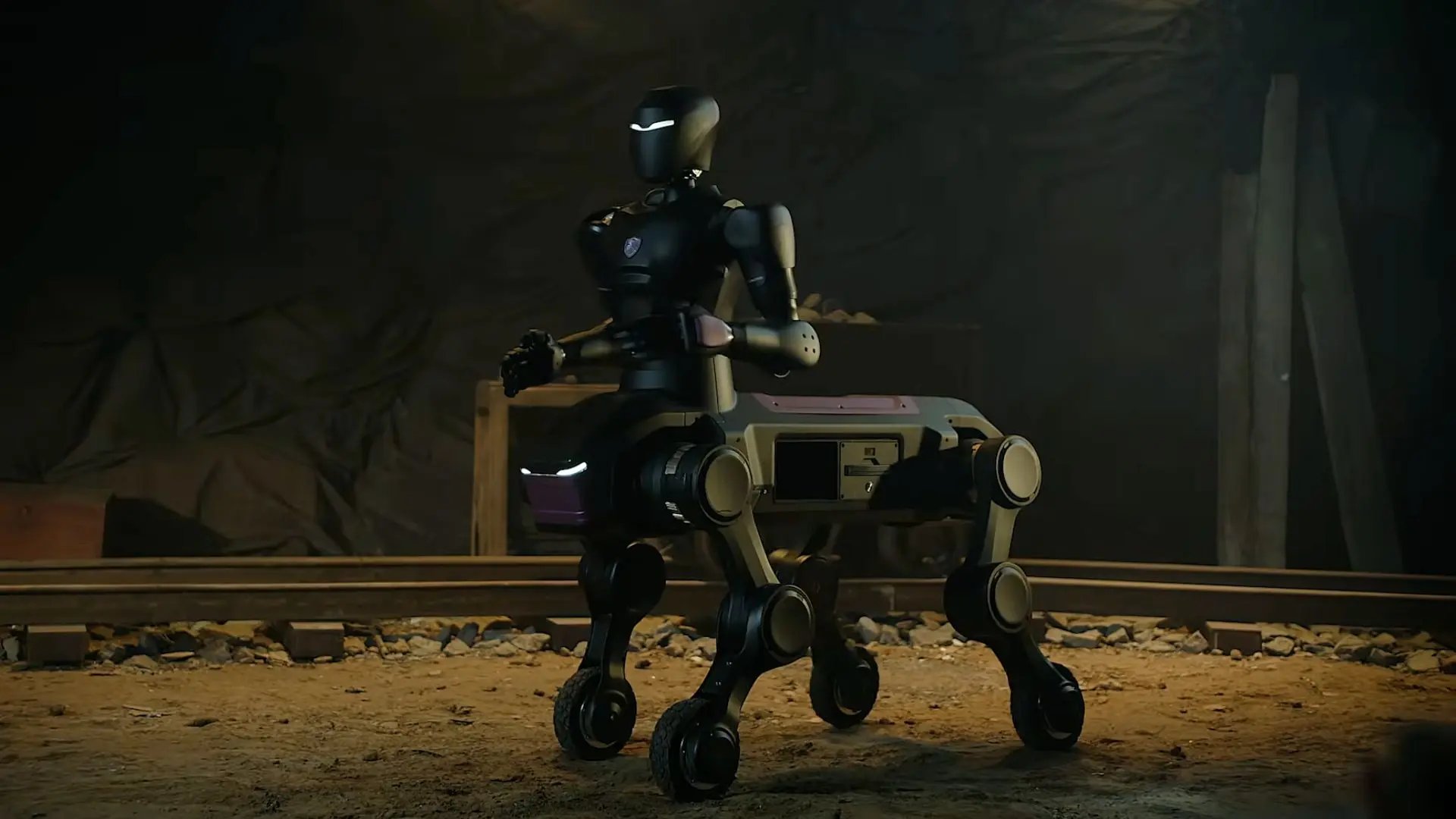 A four-wheeled centaur hybrid robot with dual robotic arms on display on an industrial test track.