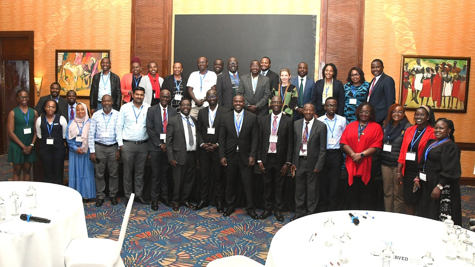 A professional group photograph of Kenyan government officials, World Bank representatives, and private sector stakeholders standing together in a conference hall following a meeting on irrigation investment.