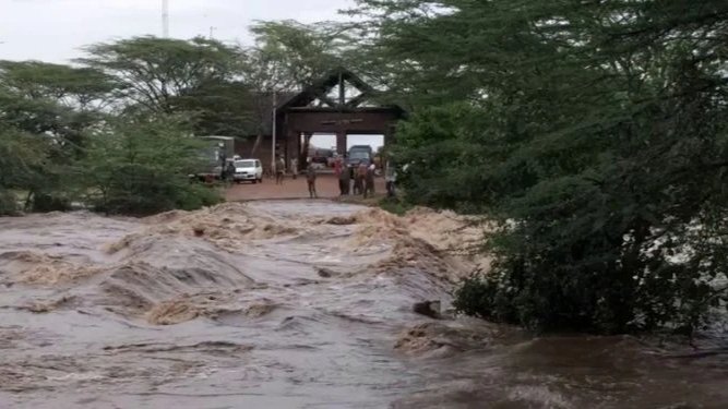Flooded section of Maasai Mara National Reserve with rising river water surrounding nearby infrastructure