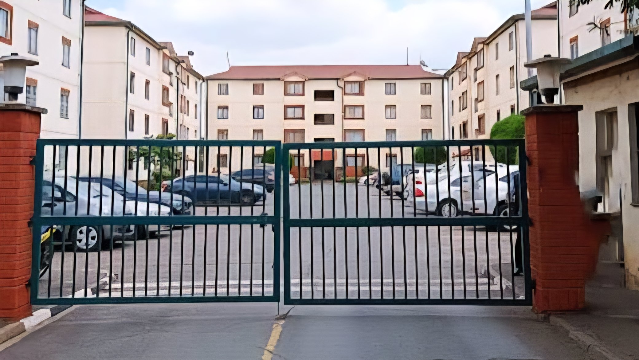 A large white rusted signboard at the entrance of Nyayo Estate Embakasi Phase 1 and 2 Gate A, with the NSSF logo visible at the top