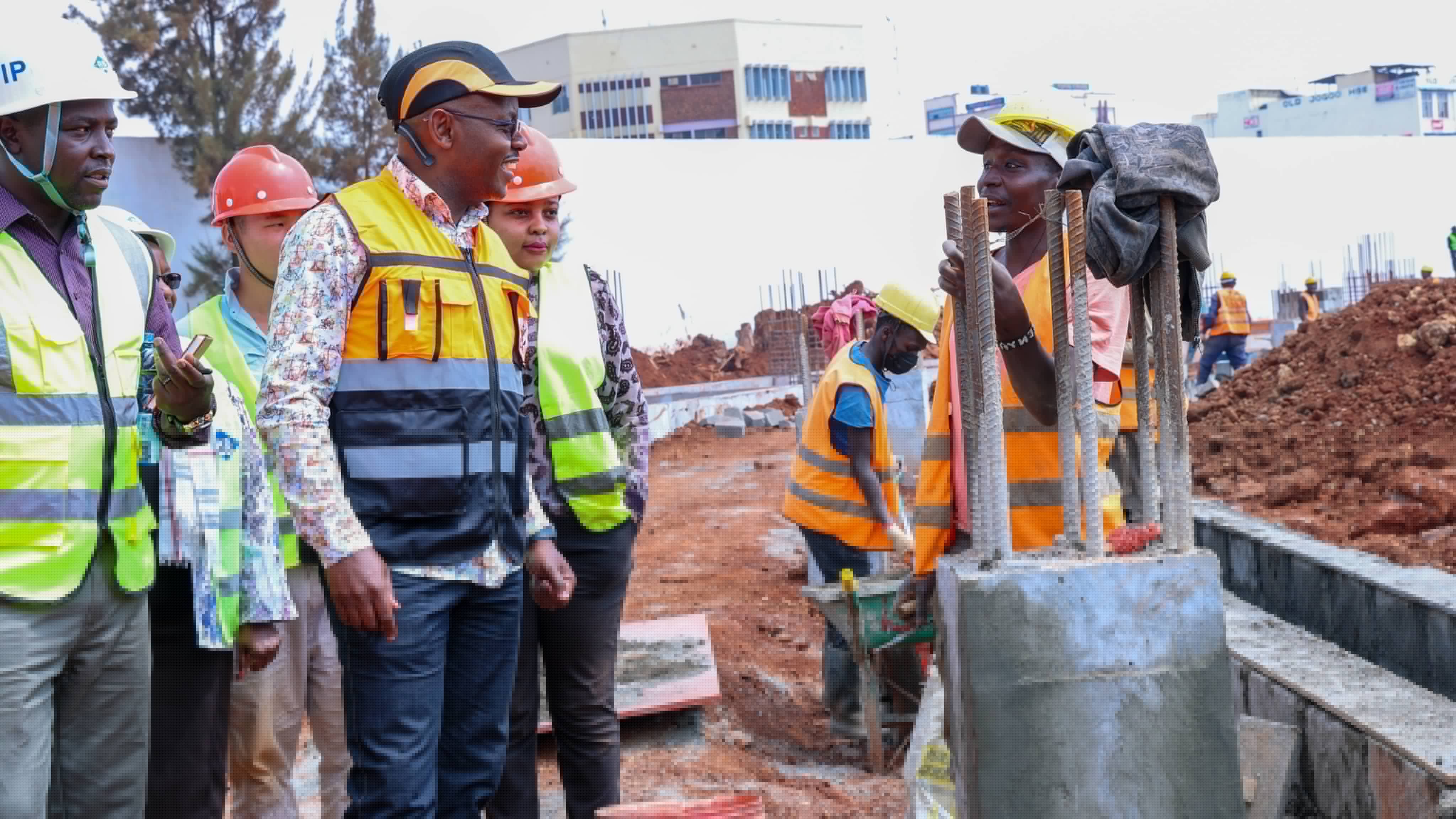 Ministry of Defence Principal Secretary Dr. Patrick Mariru inspecting rebar and concrete structures with site engineers at the Thika Stadium construction site.