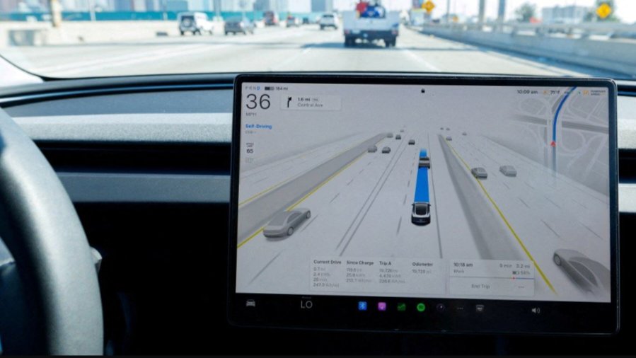 A digital screen inside a vehicle vehicle steering wheel area displays a driver-assistance interface mapping traffic, as seen in file 262584.png.