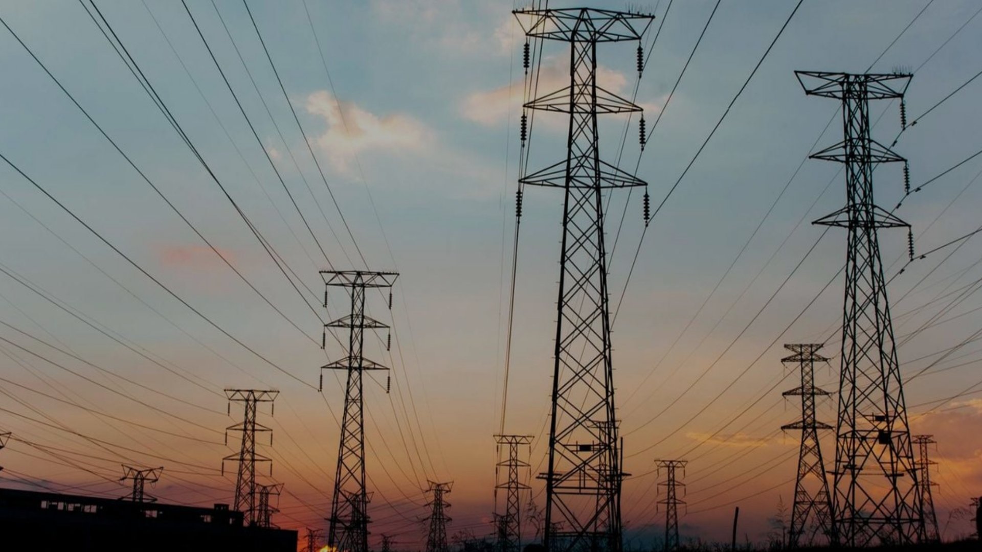 Aerial view of high-voltage transmission towers stretching across a Kenyan landscape