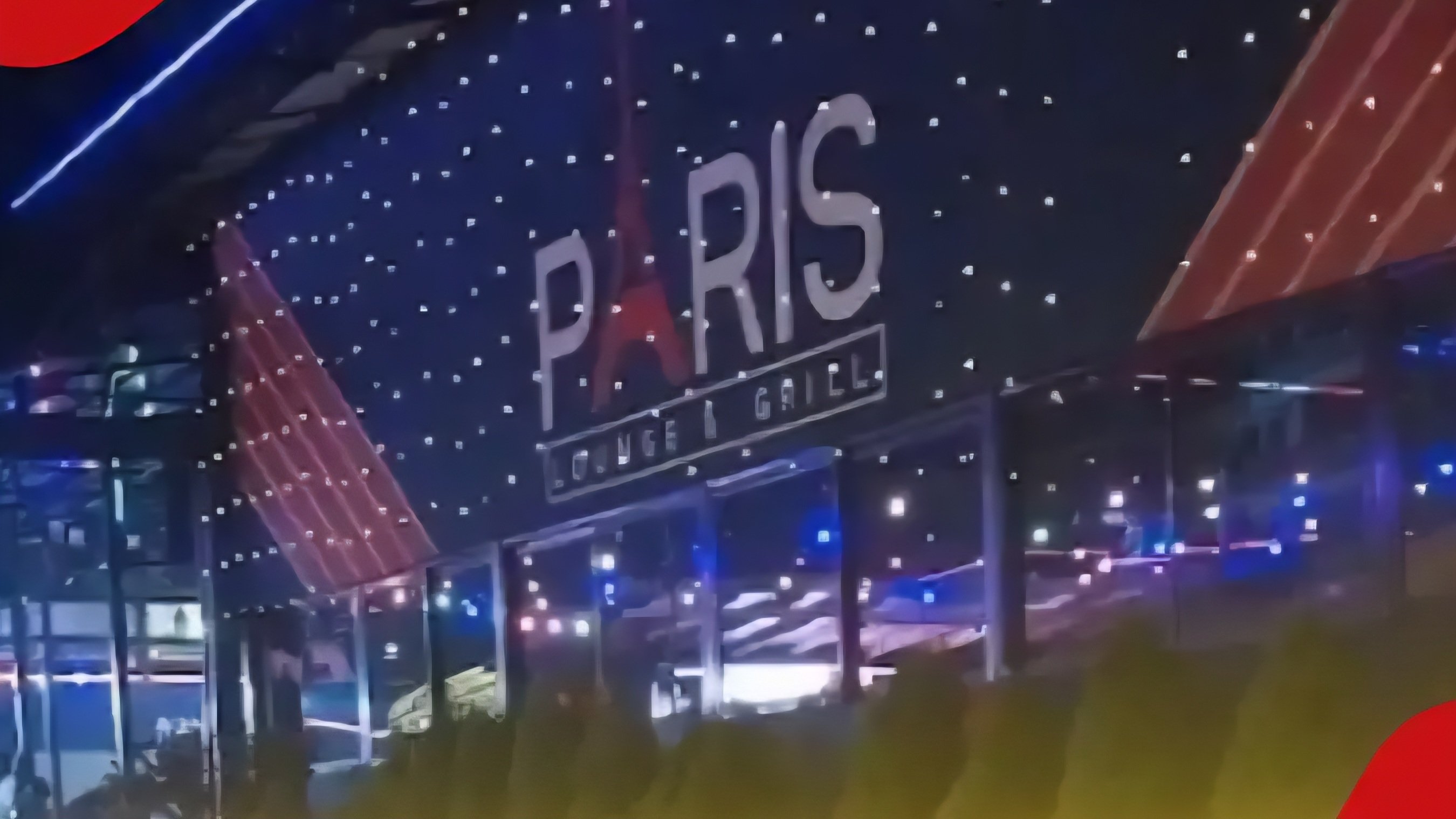 A nighttime view of the brightly lit exterior facade of the Paris Lounge & Grill establishment in Roysambu, Nairobi, showing its prominent red and blue illuminated signage.