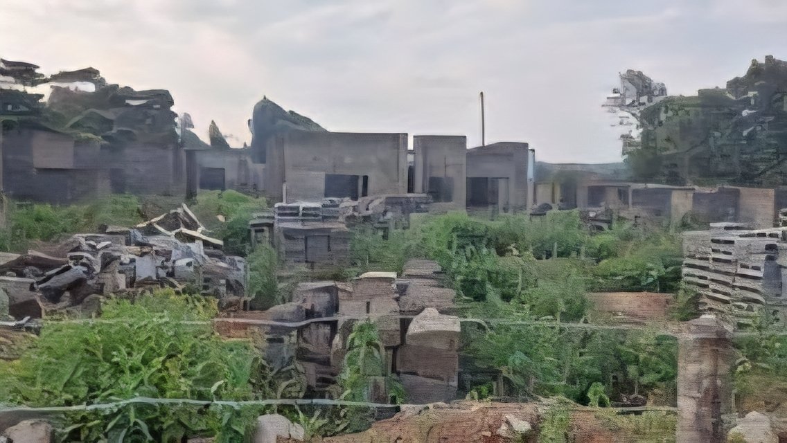 Unfinished concrete residential building structure surrounded by overgrown weeds at a stalled housing construction site in Nairobi.