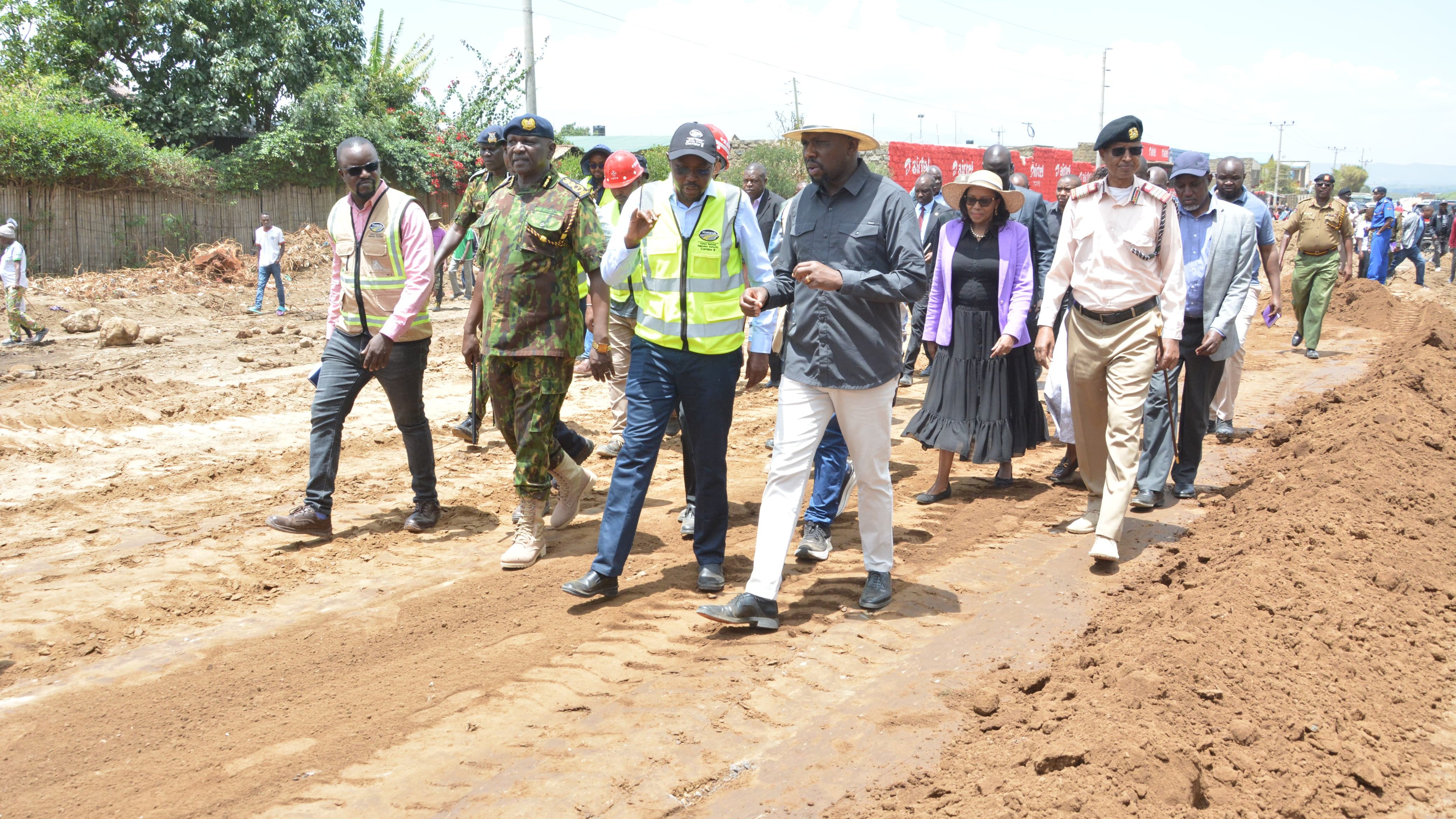 Cabinet Secretary Kipchumba Murkomen and Governor Susan Kihika walking through a construction site for the Rironi-Mau Summit Road project.