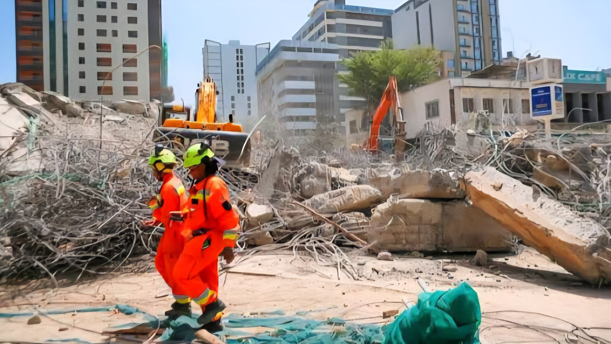 Rescue workers in orange uniforms and heavy machinery clearing debris at the site of a collapsed multi-storey building in South C, Nairobi, with high-rise buildings in the background.