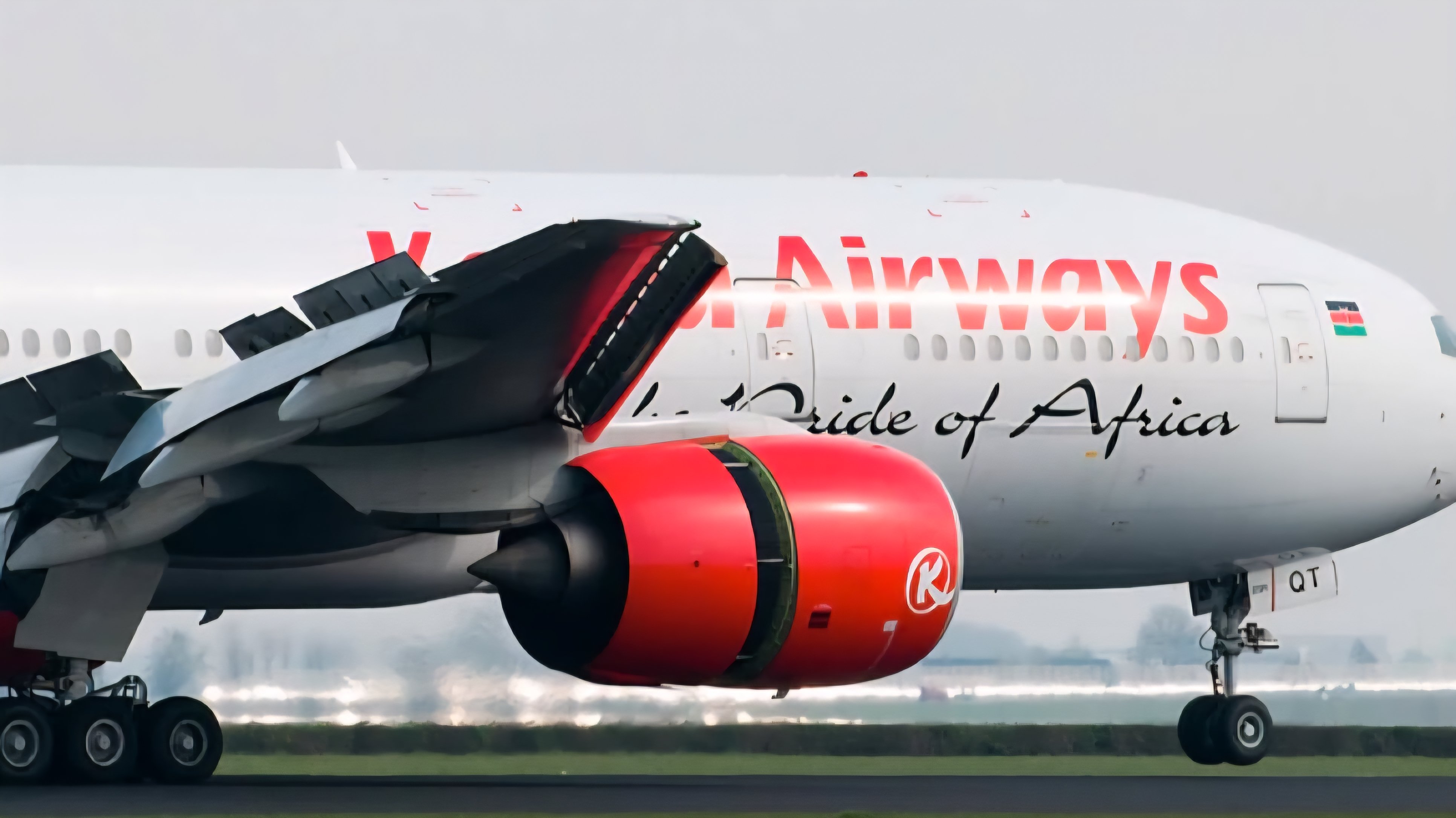 A Kenya Airways Boeing aircraft stationary on a runway with the 'Pride of Africa' branding visible on the fuselage and red engine cowlings.