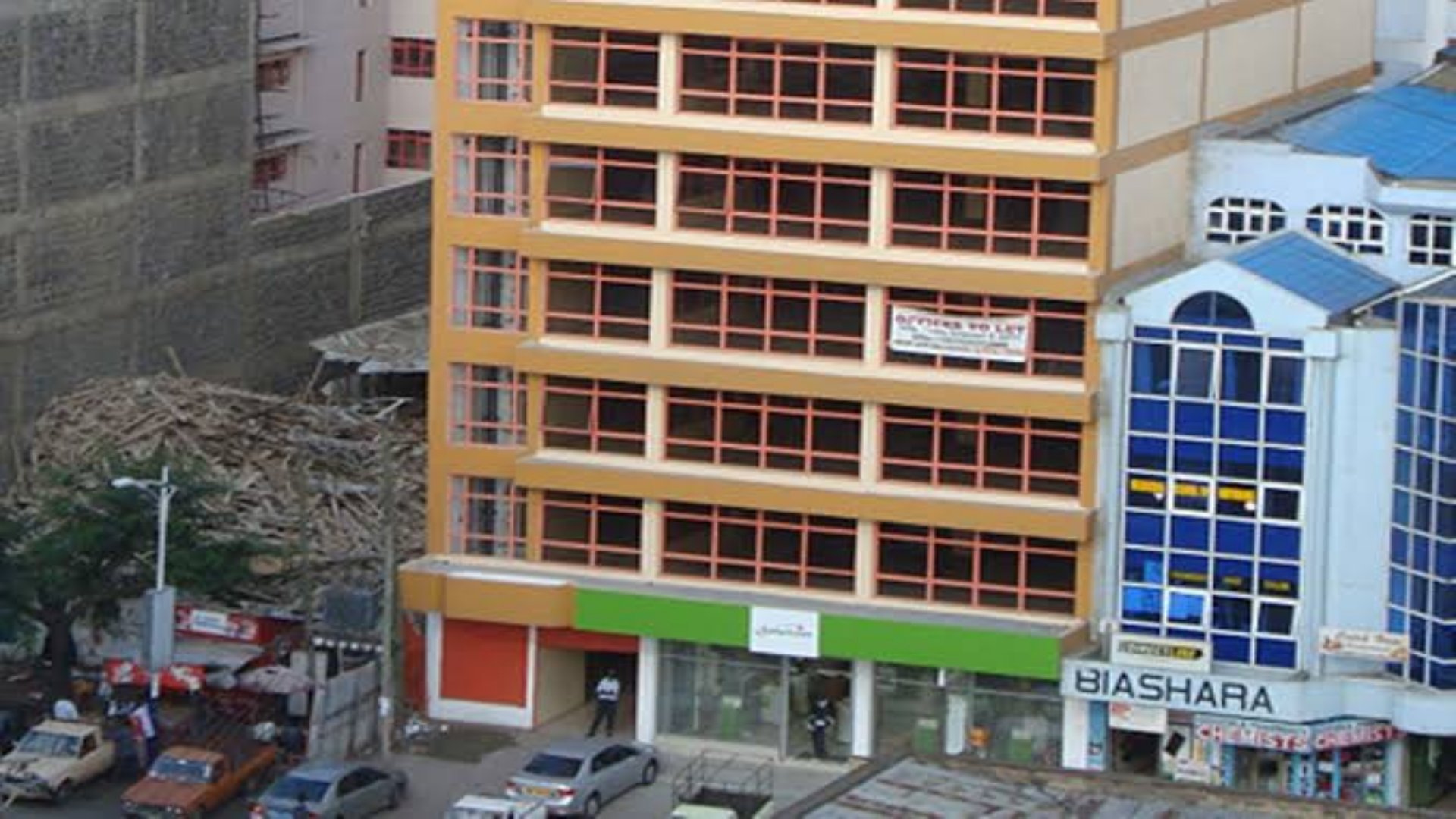 Modern glass and steel office towers standing partially vacant in a major Nairobi business district.