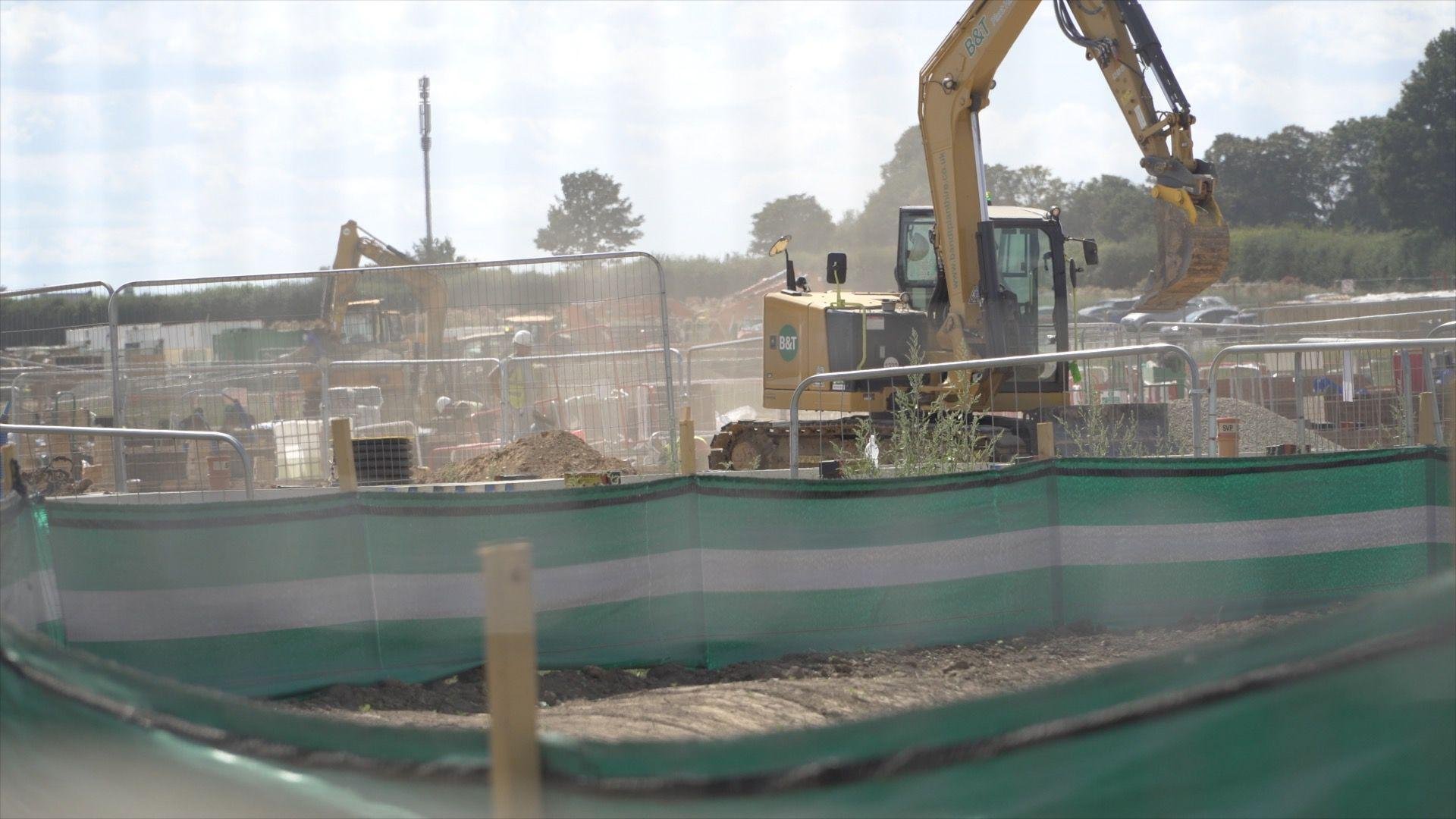 Excavators working at a dusty construction site at Ufton Court Farm near Tunstall in Kent.