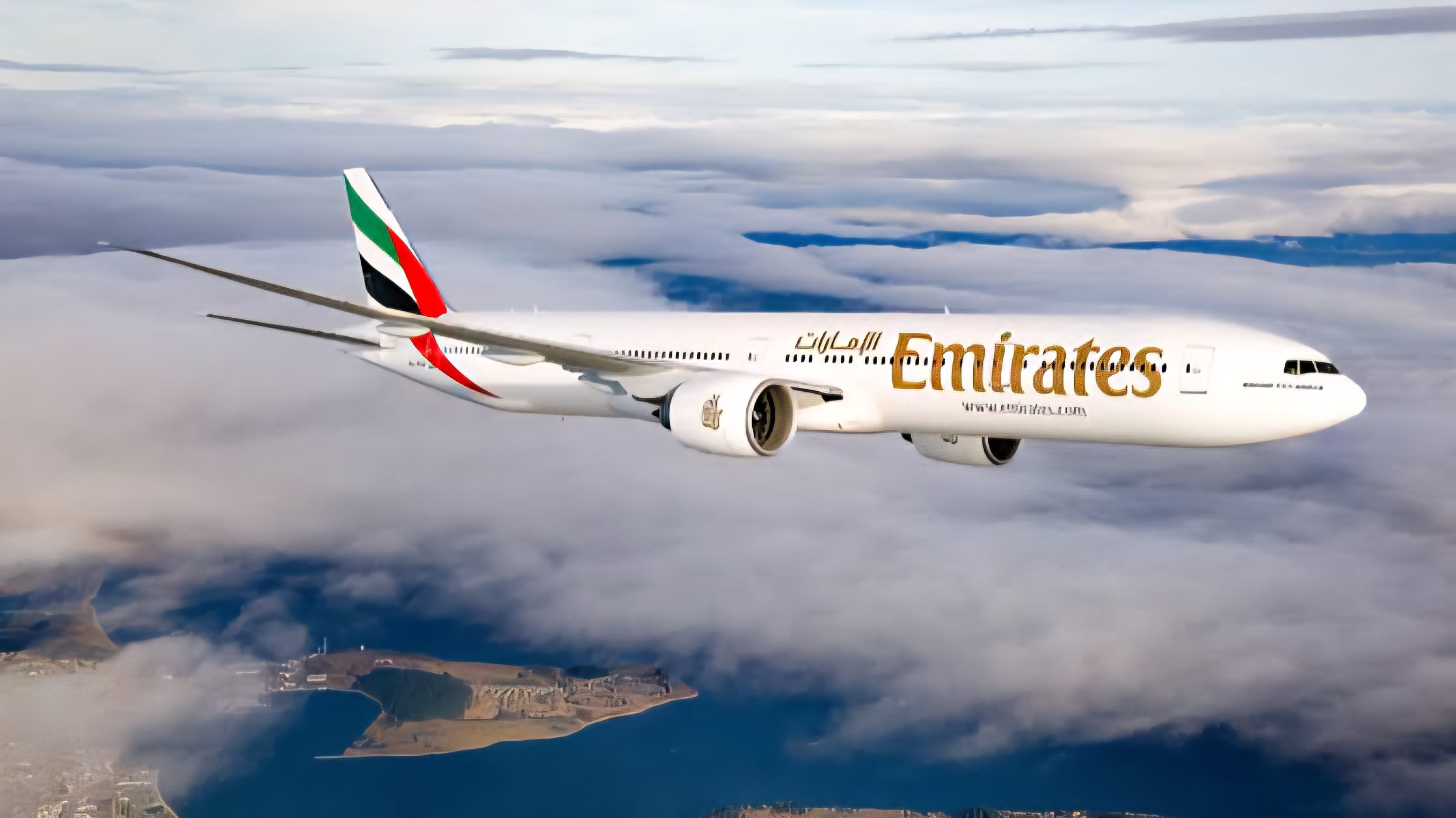 An Emirates Boeing 777 aircraft in flight against a clear blue sky, representing the airline's expanded service and new payment options in the Kenyan market.