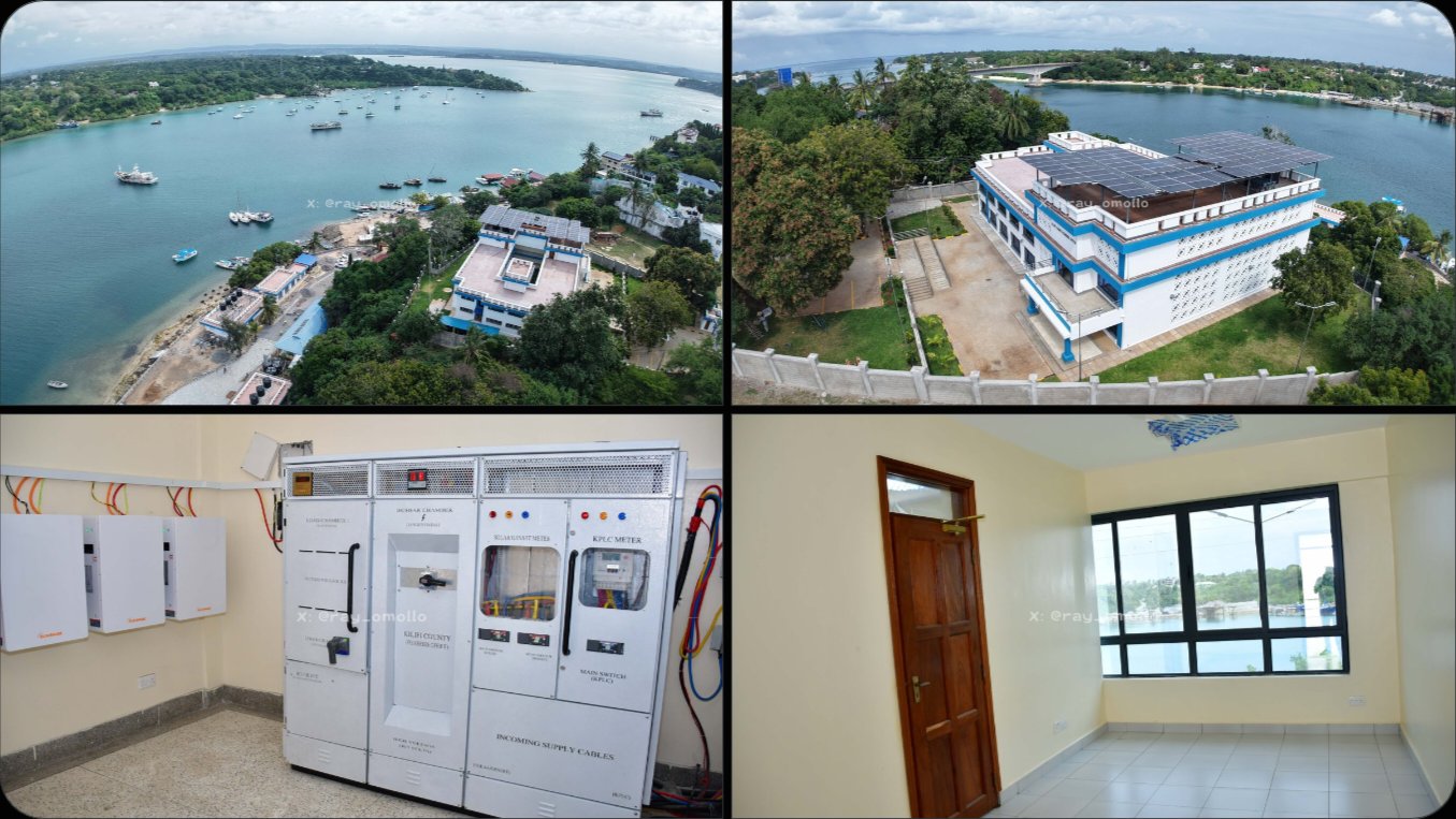 Aerial view of two-story white and blue fish landing building with rooftop solar panels near Kilifi water channel.