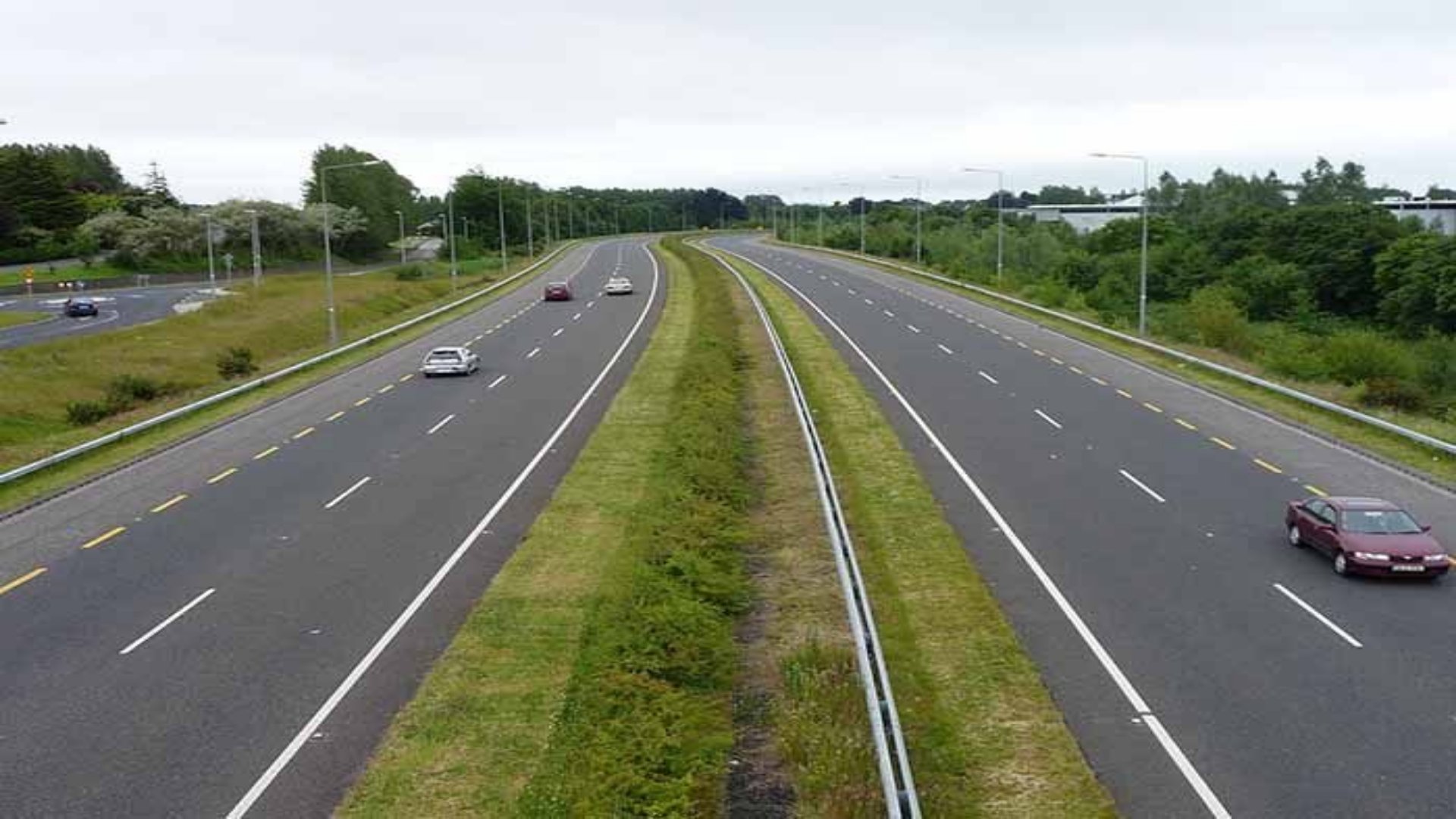 Aerial view of the new, multi-lane Kenol-Marua dual carriageway in Central Kenya, showing smooth flowing traffic and clear road markings
