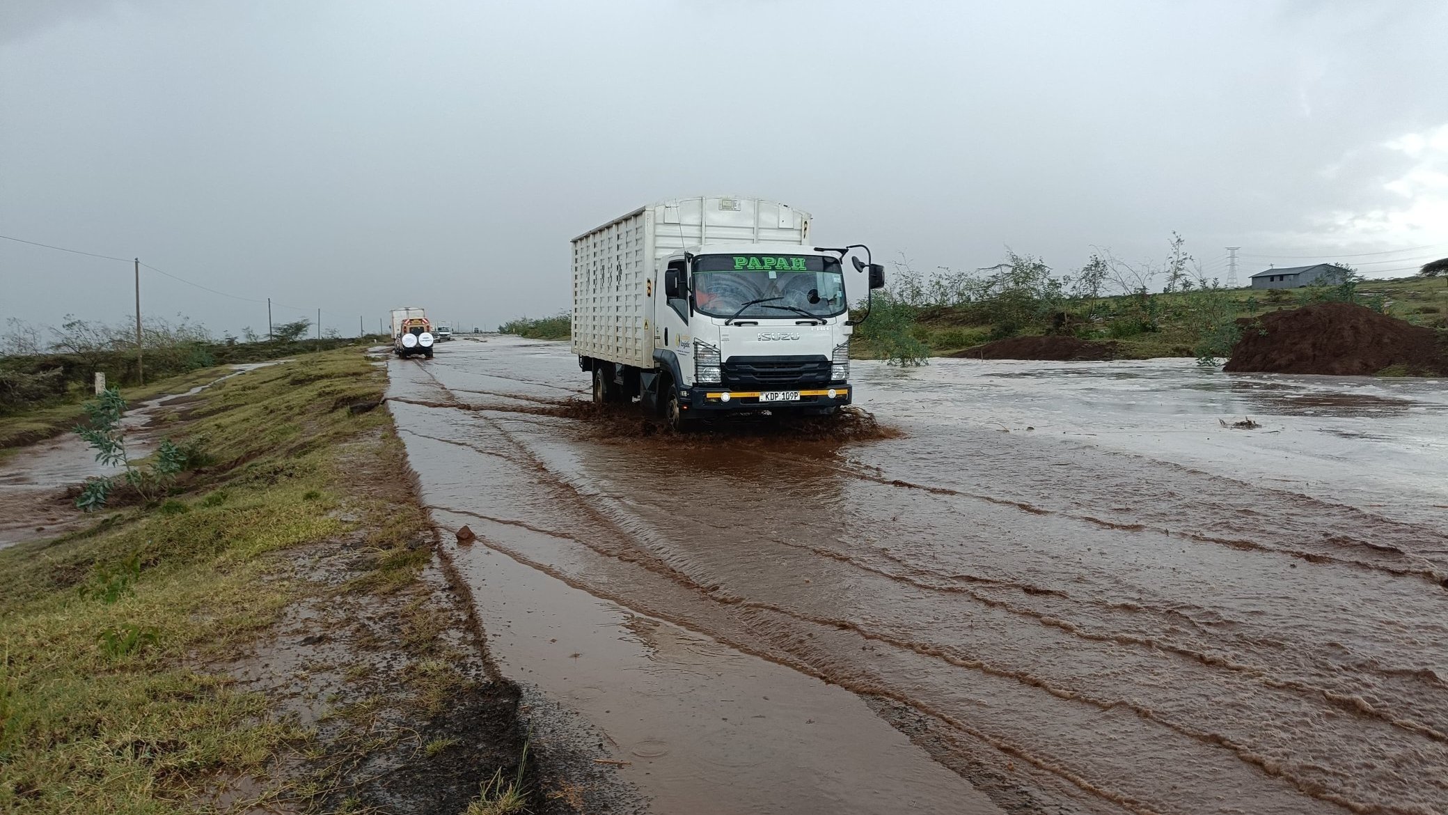 The affected section of Mai Mahiu-Suswa-Narok (B7) road with vehicles navigating through water during heavy rains