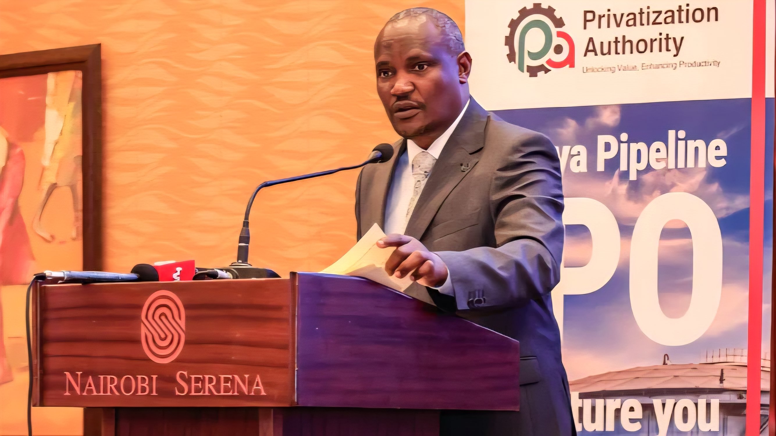 A formal presentation at the Nairobi Serena Hotel featuring a speaker at a lectern with the Privatization Authority and Kenya Pipeline logos in the background.